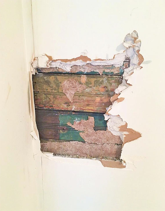 bead board peeking through drywall hole