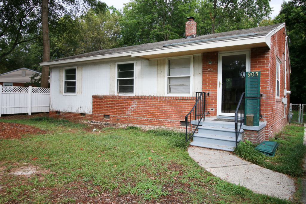 front brick ranch with original siding exposed