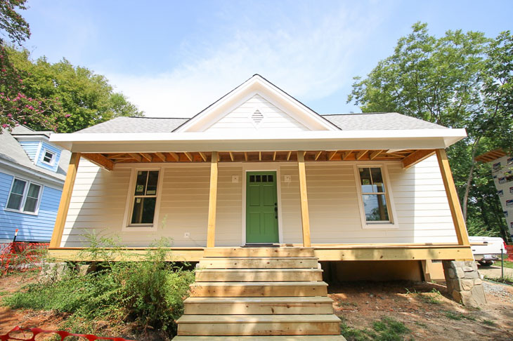 Off white farmhouse exterior house color, green door